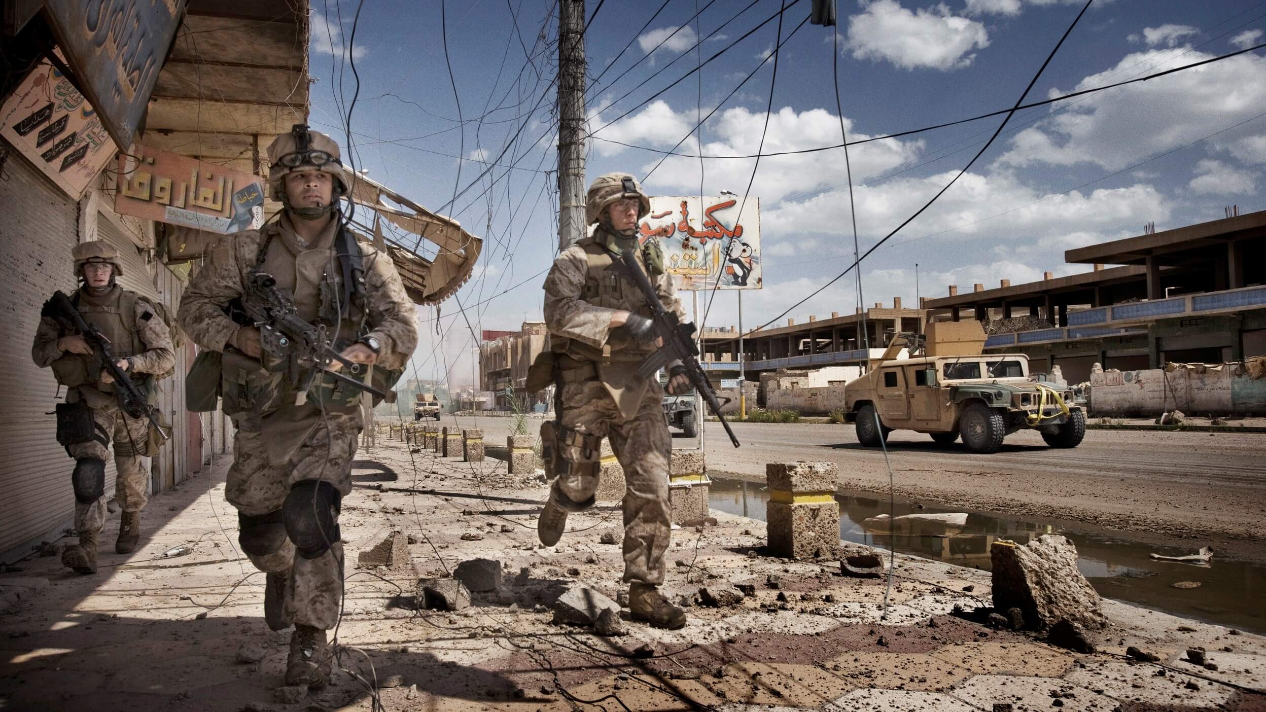 U.S. Marines from the 3rd Battalion, 8th Marine Regiment, Kilo company scan streets and surrounding buildings for insurgents during a patrol in Ramadi, 115 kilometers west of Baghdad. By: Yuri Kosyrev