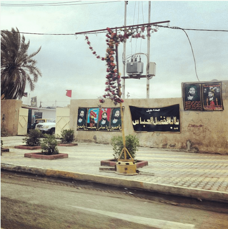 Street signs, which depict images of holy persons in Islam, litter the streets of Baghdad (2012). 
